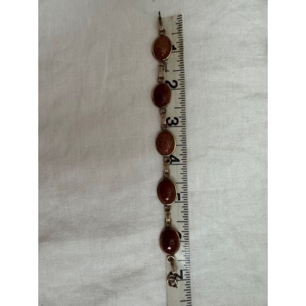 Vintage MCM Goldstone gold tone bracelet.